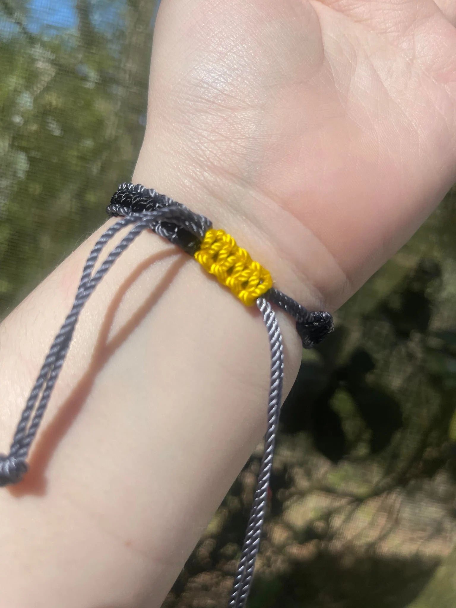 Yellow slide clasp of the black and grey batman bracelet